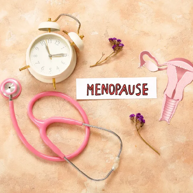 Stethoscope and clock beside a Menopause card, representing doctor-led nutrition guidance